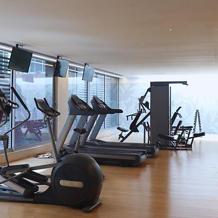 Vip Grand Lisboa Hotel & Spa Exterior photo The photo shows a modern gym or fitness area. It features several pieces of exercise equipment, including treadmills, elliptical machines, and a multi-gym station for strength training. The space has large windows that allow natural light to enter, c